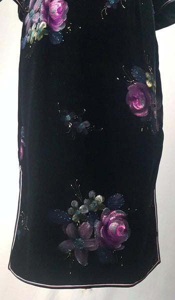 Hemline view with contrasting piping and hand-painted pink floral design on a 1950s black velvet cheongsam qipao dress