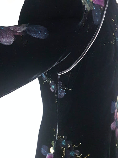 Sleeve lifted to show zipper view of a 1950s black velvet cheongsam qipao dress with a hand-painted pink floral design 