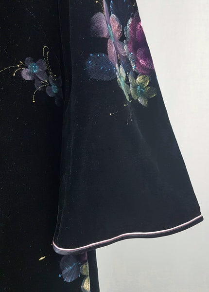 Sleeve view with contrasting piping and hand-painted pink floral design on a 1950s black velvet cheongsam qipao dress