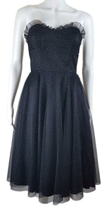 A vintage 1980's Gunne Sax black formal dress with a pleated tulle sweetheart neckline and multicolor glitter dots, featuring a fitted bodice and full sweep skirt with a built-in crinoline.