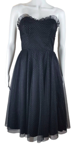 A vintage 1980's Gunne Sax black formal dress with a pleated tulle sweetheart neckline and multicolor glitter dots, featuring a fitted bodice and full sweep skirt with a built-in crinoline.