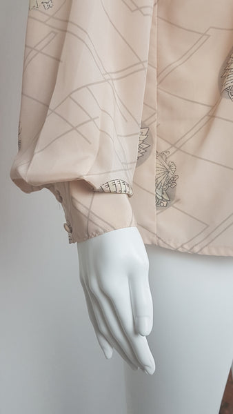 cuff and sleeve detail on Vintage 1980s pastel peach Jac Dale shirt with long sleeves, a pointed collar, and an abstract grey fan print on a mannequin