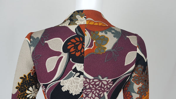 Vintage Y2K cropped jacket displayed on a mannequin, featuring three-quarter sleeves and an abstract floral print in plum, rust, cream, black and grey - back shoulder view