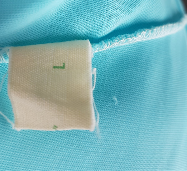 Label of Canadian Maid Vintage 1960's Azure Blue Gathered Yoke Robe with silver and white decorative details on bust and sheer sleeves displayed on a mannequin