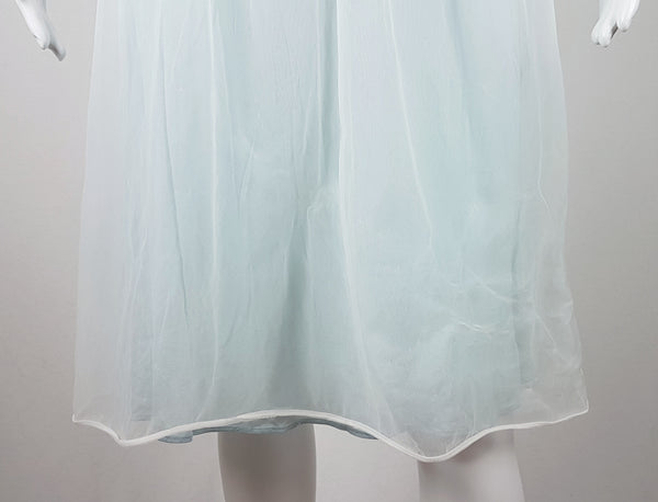 Vintage 1960s Aristocraft by Superior pastel blue nightgown with cream floral lace and ribbon ties displayed on a mannequin - bottom hem view