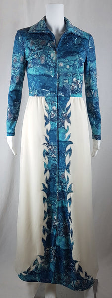 Vintage 1970s Missy House of Canada maxi dress with an aqua blue patterned bodice, long sleeves, pointed collar, and a white skirt with coordinating abstract panels shown on a mannequin