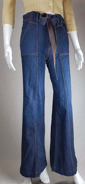 Full front view of deadstock 7 For All Mankind indigo palazzo jeans with a knotted denim belt, large patch pockets and wide legs displayed on a mannequin