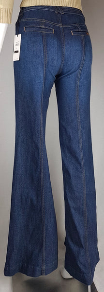 Full back view of deadstock 7 For All Mankind indigo palazzo jeans with a knotted denim belt, large patch pockets and wide legs displayed on a mannequin