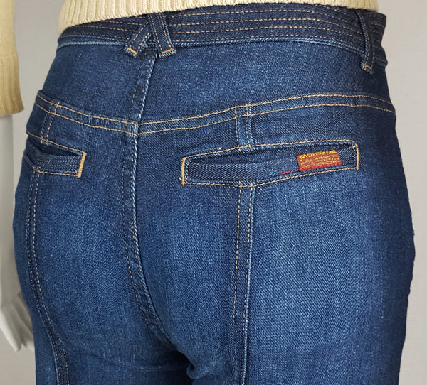 Close-up of the rear waistband, shaped seams and two welt pockets on 7 For All Mankind indigo jeans