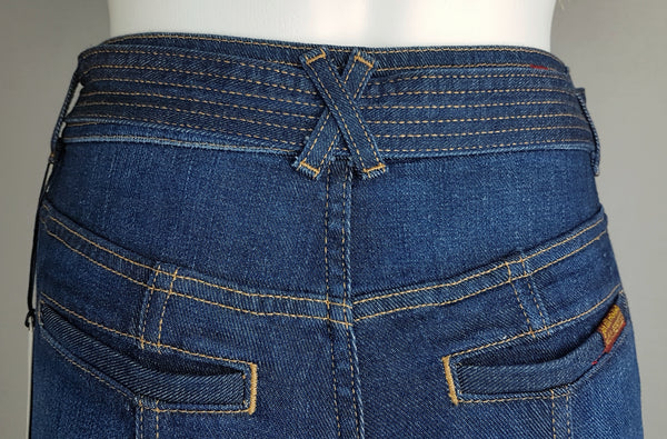 Close-up of the rear waistband, shaped seams and two welt pockets on 7 For All Mankind indigo jeans