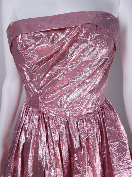 Close-up of strapless bodice with diagonal draping and metallic pink lamé crinkled finish