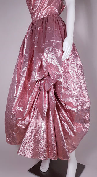 Side view of pink lamé gown with dramatic asymmetrical picked-up skirt