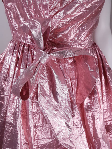 Front waist detail of pink lamé gown with gathered skirt and draped fabric accent