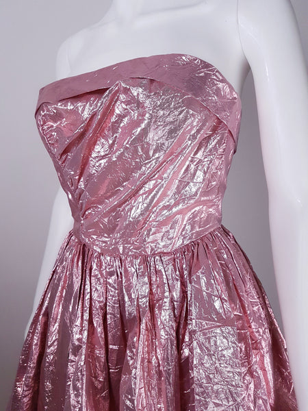 Angled Close-up of strapless bodice with diagonal draping and metallic pink lamé crinkled finish