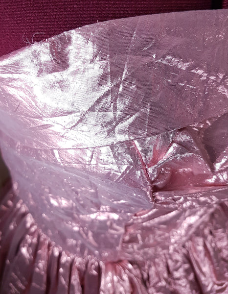 Close-up of surface wear and small damaged area near the bodice waist seam