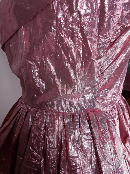Side close-up of fitted bodice, gathered waist and metallic lamé fabric