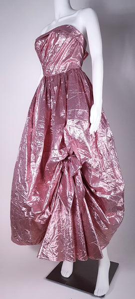 Three-quarter view of Vintage 1980s metallic pink lamé strapless prom gown by TD4 by Eletra with full skirt and asymmetrical gathered detail