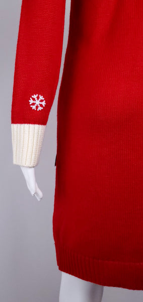 Side detail showing the cream ribbed cuff, embroidered sleeve snowflakes and plain red back