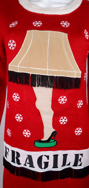 Close-up of the dimensional leg-lamp appliqué with beige lampshade, black fringe and FRAGILE lettering