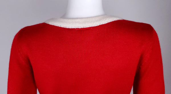 Upper back view showing the plain red knit and cream ribbed round neckline