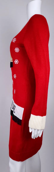 Side view of the long-sleeved red sweater dress showing its straight knee-length silhouette