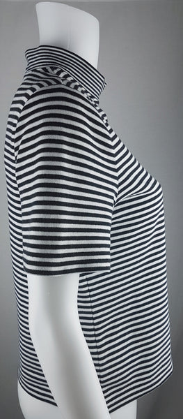 Full side view of an Alia black and white striped knit top with short sleeves, a mock neckline and a softly fitted silhouette.