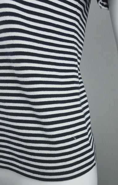 Detailed side view of the fine black and white striped knit, side seam and lower hem of an Alia top.