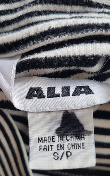 Close-up of the Alia label and size tag marked S/P and Made in China.