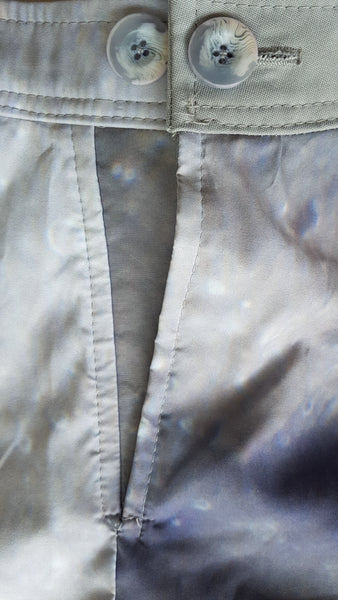 Interior close-up of the marbled two-button waistband fastening and V-shaped modesty panel beneath the skirt opening.
