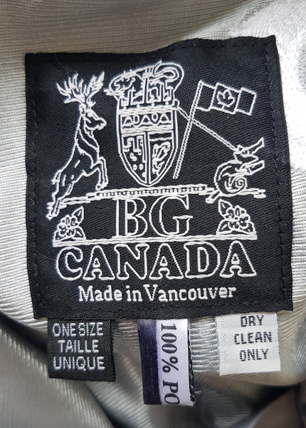 Close-up of the BG Canada Made in Vancouver label, One Size tag and 100% polyester care label.
