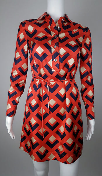 Banana Republic Madmen Collection silk red and navy geometric print shirt shift dress with a 5 button front bodice closure and matching string belt on a mannequin - front view