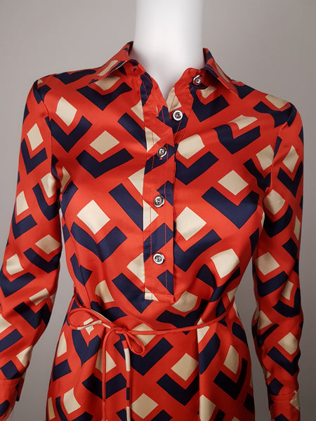 Banana Republic Madmen Collection silk red and navy geometric print shirt shift dress with a 5 button front bodice closure and matching string belt on a mannequin - bust and belt view