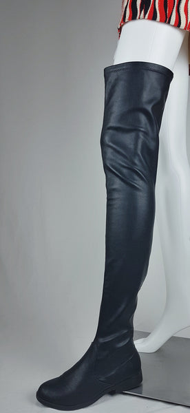 Black vegan leather over-the-knee boots with a smooth texture and a slight sheen, featuring a partial side zip closure and an almond-shaped toe displayed on a mannequin - three quarter view