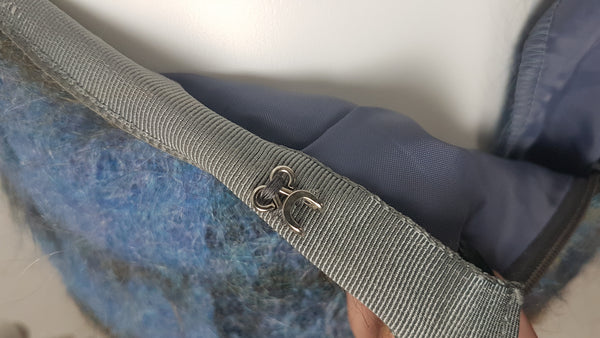 Hook and eye closure for Vintage 1970s Andrew Stewart mohair and wool pencil skirt with a fuzzy plaid pattern in blue, brown, grey, and olive shown on mannequin