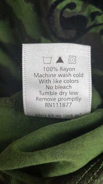 Care label for Green and black patterned “LOVE” T-shirt top from Gwen Stefani’s Fall 2005 L.A.M.B. collection, with an ornate black chest motif.