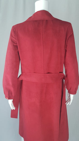 Back view of Vintage 1970's Halston Ultra Suede red knee length wrap coat dress with long sleeves, a wide collar, and a matching tie belt on a mannequin 