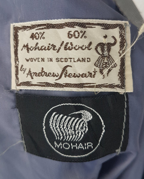 Label for Vintage 1970s Andrew Stewart mohair and wool pencil skirt with a fuzzy plaid pattern in blue, brown, grey, and olive shown on mannequin