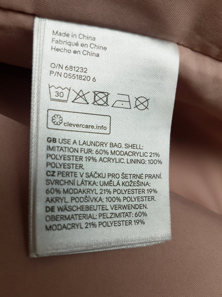 H&M care label showing faux-fur fibre composition and care instructions