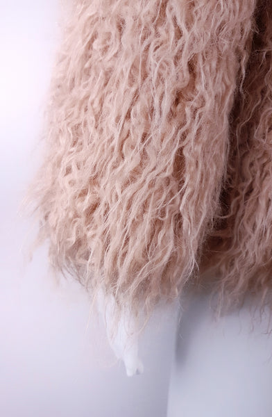 Close-up of shaggy faux-fur sleeve and softly curled pink pile