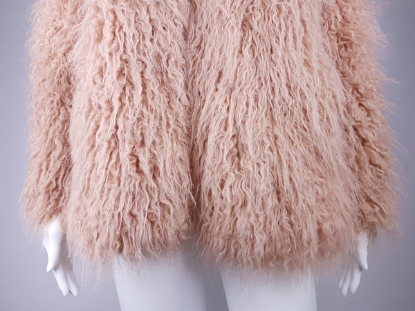 Close-up of shaggy faux-fur sleeves, bottom of jacket, and softly curled pink pile