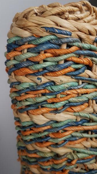 Side close-up showing twisted blue, mint, coral and brown strands within the open natural weave