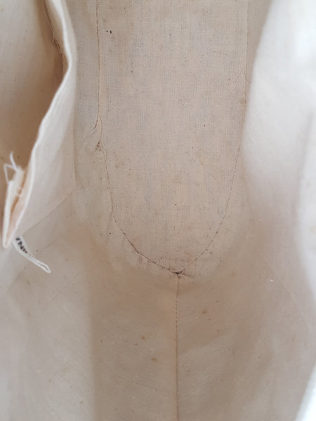 Interior lining showing scattered spotting and discolouration around the base seam
