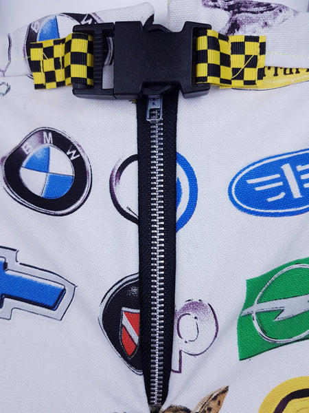 Close-up of the exposed metal front zipper beneath the checkerboard waist belt