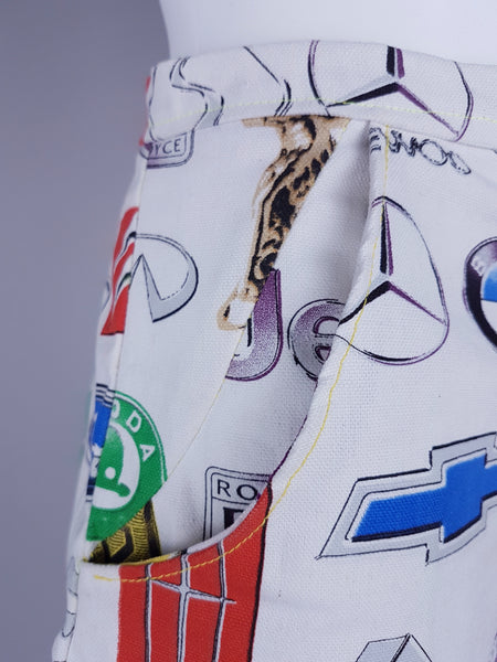 Close-up of the side construction, pockets, and illustrated automotive emblems on the structured woven fabric