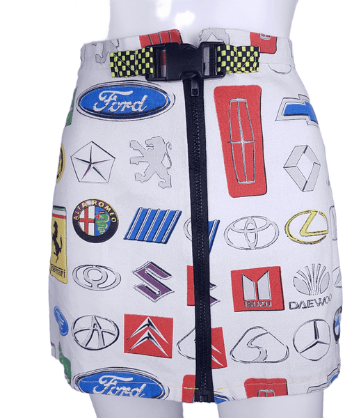 Front view of an automotive-logo mini skirt with a full-length exposed zipper and neon checkerboard belt