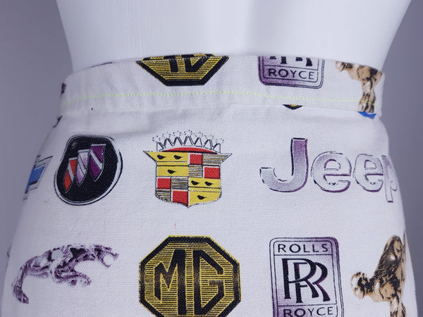 Close-up of the rear waistband and automotive print featuring Jeep, Cadillac, MG and Rolls-Royce emblems