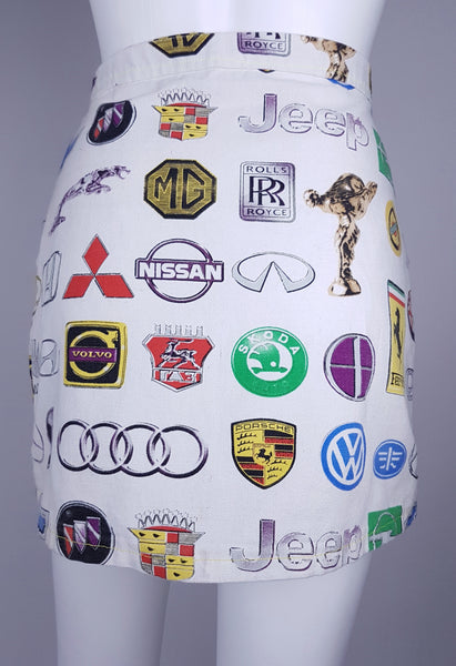 Rear three-quarter view showing the gently flared mini shape and all-over automotive-logo print