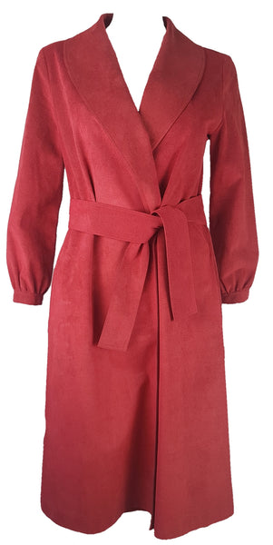 Vintage 1970's Halston Ultra Suede red knee length wrap coat dress with long sleeves, a wide collar, and a matching tie belt on a mannequin 