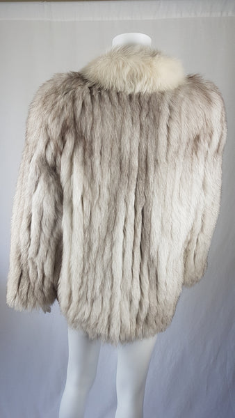 Saga Fox Pale blue fox fur jacket with long sleeves, a plush collar, and natural silver grey markings on a mannequin