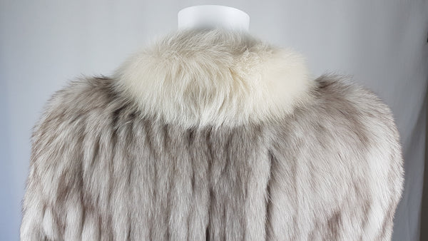 Saga Fox Pale blue fox fur jacket with long sleeves, a plush collar, and natural silver grey markings on a mannequin